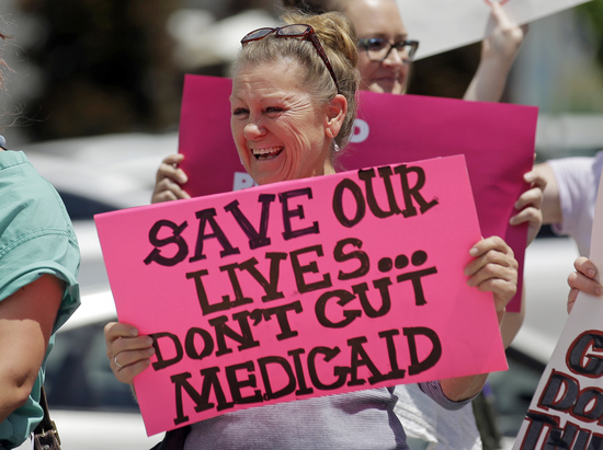 FILE - In this June 27, 2017 file photo, protesters block a street during a demonstration against the Republican bill in the U.S. Senate to replace former President Barack Obama's health care law, in Salt Lake City. The Trump administration will allow Medicaid expansion with a work requirement in Utah, a decision that came Monday, Dec. 23, 2019, despite courts taking a dim view of the requirement in other states. (AP Photo/Rick Bowmer, File) FILE - In this June 27, 2017 file photo, protesters block a street during a demonstration against the Republican bill in the U.S. Senate to replace former President Barack Obama's health care law, in Salt Lake City. The Trump administration will allow Medicaid expansion with a work requirement in Utah, a decision that came Monday, Dec. 23, 2019, despite courts taking a dim view of the requirement in other states. (AP Photo/Rick Bowmer, File)