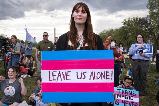 Runa Morgen, from upstate New York holds a sign saying "leave us alone," during a rally for the Trans Day of Visibility, on the National Mall, Monday, March 31, 2025, in Washington. "What's going on is scary," says Morgan, "there's an obvious pattern and I see where this is going." (AP Photo/Jacquelyn Martin) Runa Morgen, from upstate New York holds a sign saying "leave us alone," during a rally for the Trans Day of Visibility, on the National Mall, Monday, March 31, 2025, in Washington. "What's going on is scary," says Morgan, "there's an obvious pattern and I see where this is going." (AP Photo/Jacquelyn Martin)