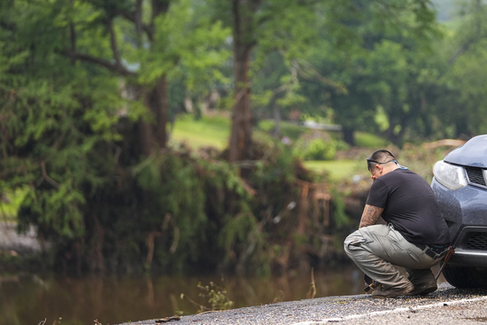 Avi Santos, 23, of San Antonio, Texas, reacts while stopping on the road alongside at Camp Mystic along the banks of the Guadalupe River after a flash flood swept through the area Sunday, July 6, 2025, in Hunt, Texas. (AP Photo/Julio Cortez) Avi Santos, 23, of San Antonio, Texas, reacts while stopping on the road alongside at Camp Mystic along the banks of the Guadalupe River after a flash flood swept through the area Sunday, July 6, 2025, in Hunt, Texas. (AP Photo/Julio Cortez)